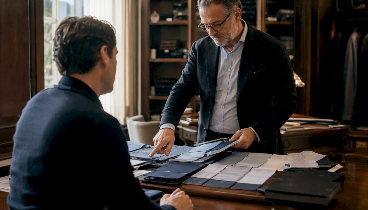Tailor consulting client on bespoke shirt placket