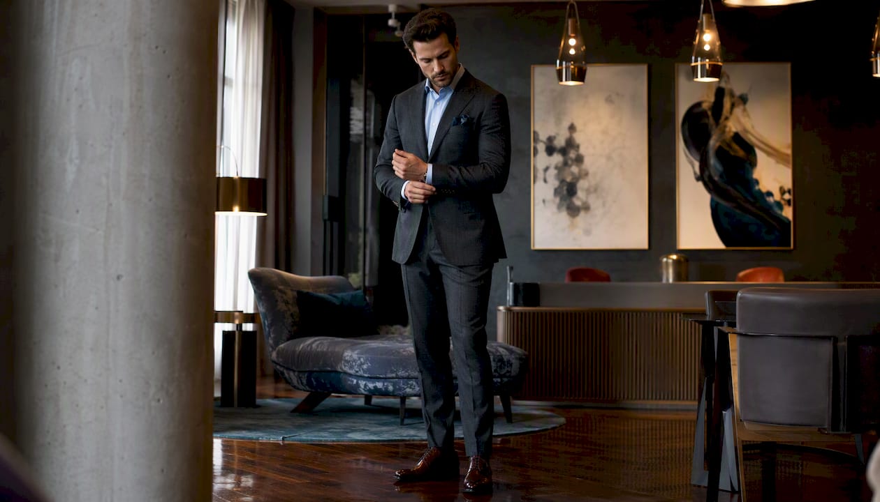 Man in cocktail suit standing in elegant hotel lobby