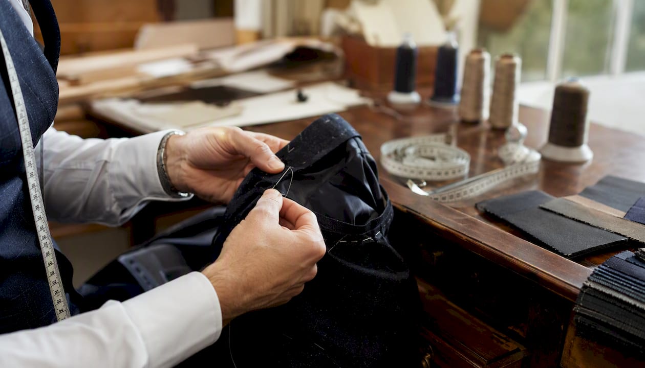 Tailor sewing canvas interlining in jacket chest