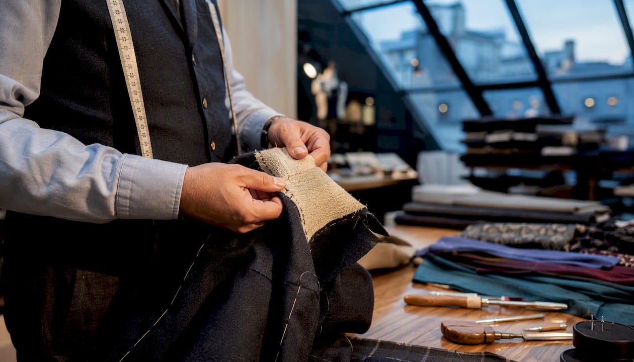 Tailor sewing canvas layer into jacket chest