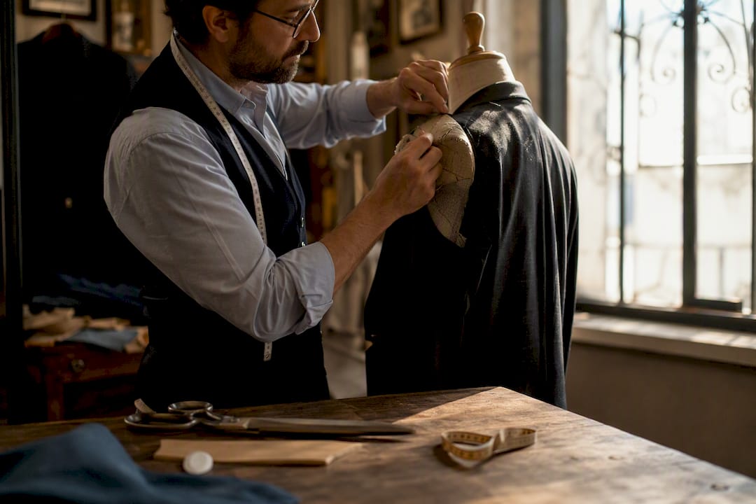 Tailor shaping soft shoulder jacket on dress form