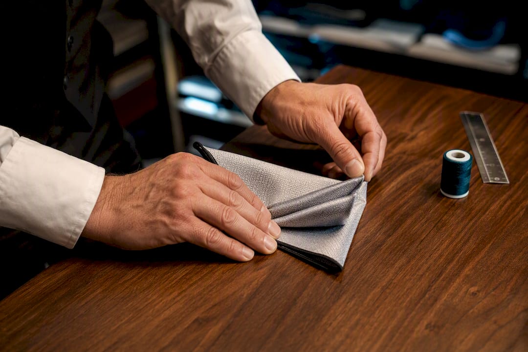 Hands folding a pocket square