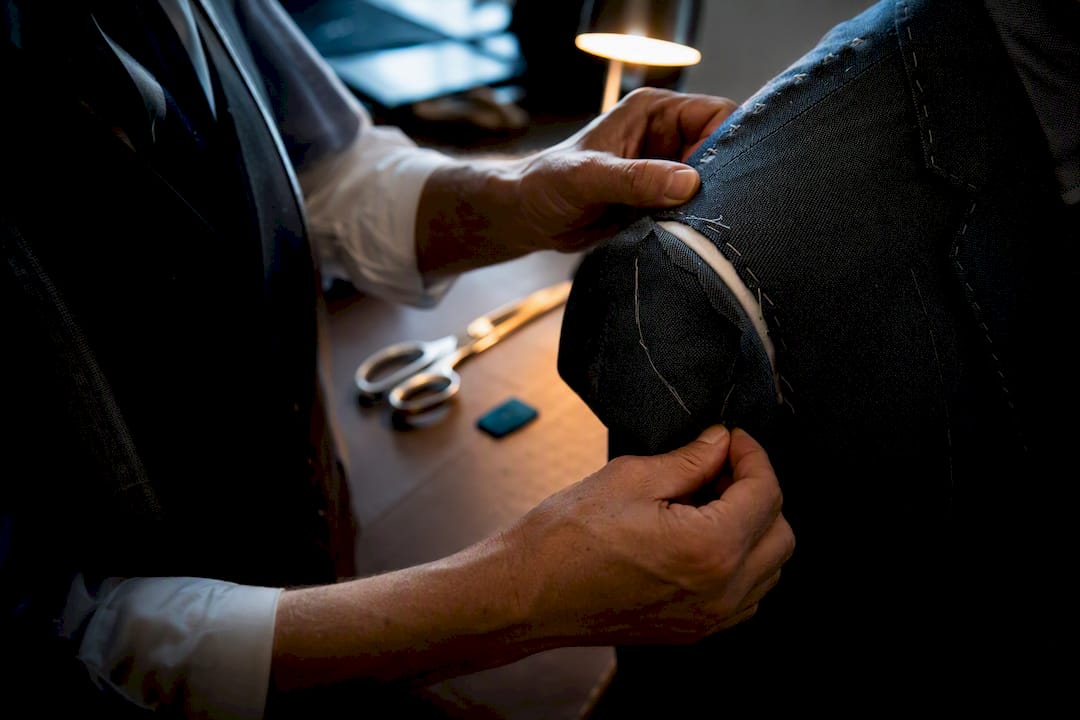 Tailor rebuilding a jacket shoulder seam