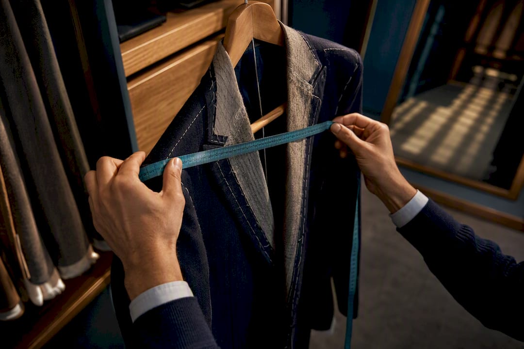 Hands measuring jacket at home