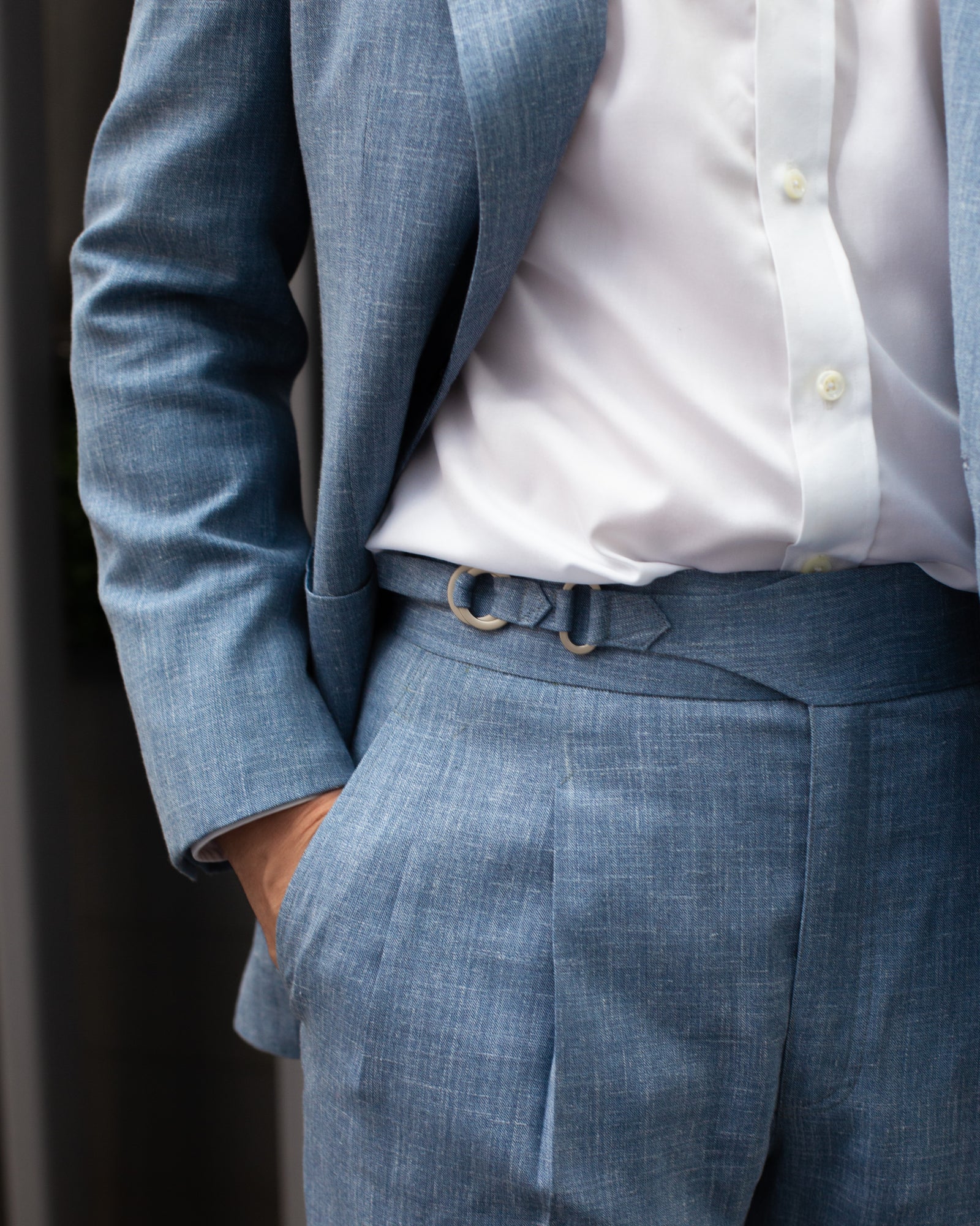 Trousers with side adjusters and a white shirt