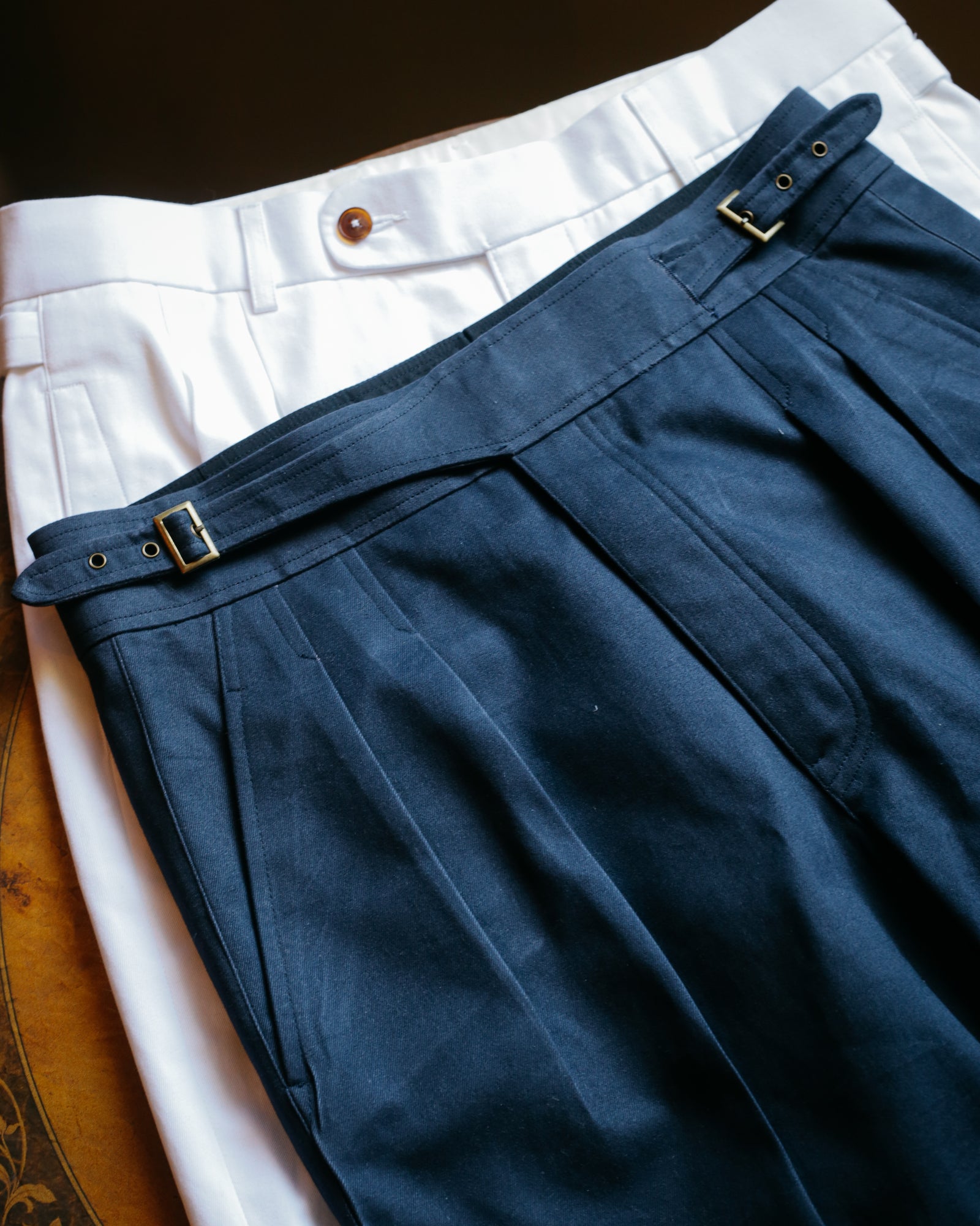 Blue pleated bespoke trousers with side adjusters