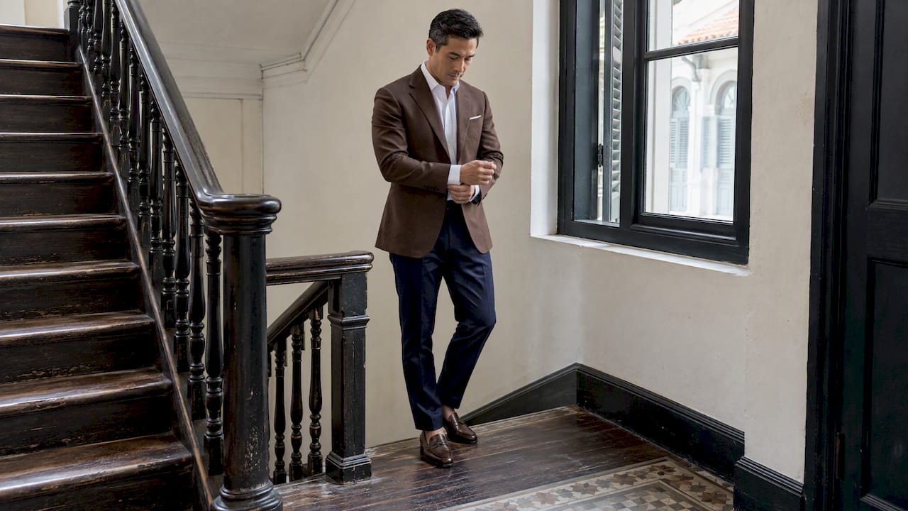 Brown jacket styled separately with navy trousers