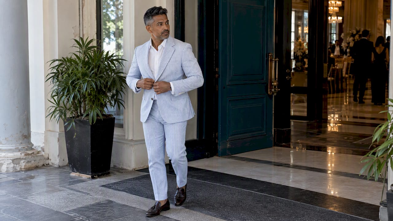 Man wearing a blue and white seersucker suit