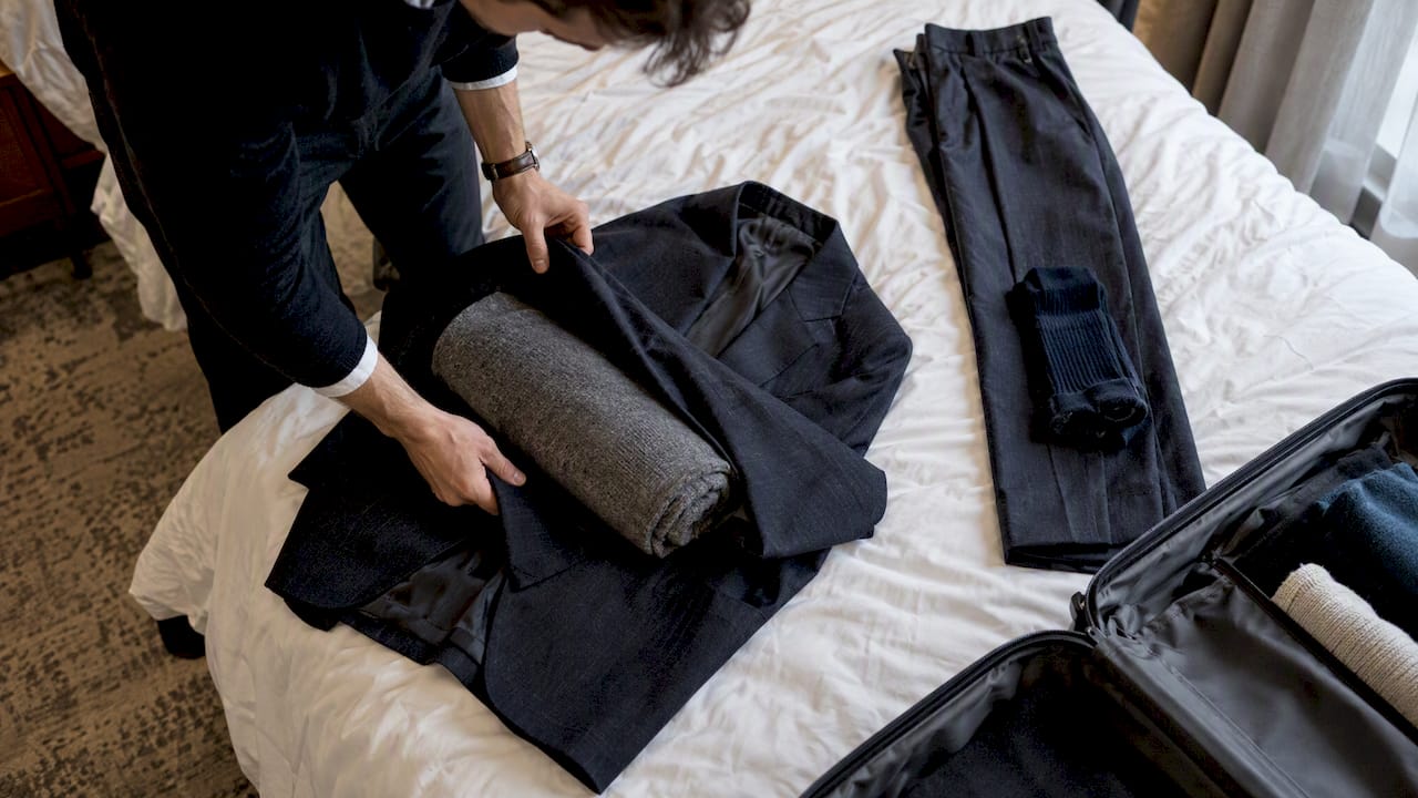 Suit folded with sweater and socks for travel